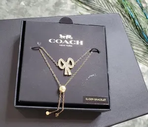 Coach Gold Tone Studded Bow Slider Bracelet‎ thumbnail 1