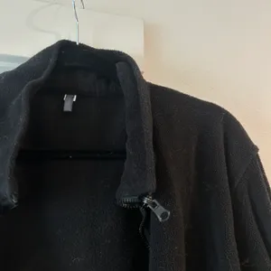 Black fleece zip up jacket with adjustable drawstrings in medium thumbnail 2