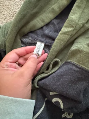 black and green label of 10,000 ice rinks hooded sweatshirt thumbnail 3