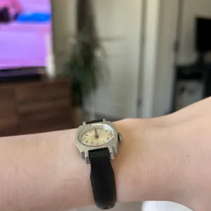 1970s silver vintage Timex women's mechanical winding watch featuring a cushion-shaped case and a leather band thumbnail 2