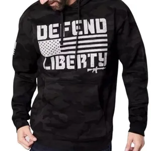 Howitzer "Defend Liberty" Black Camo Hoodie Elevate your casual wear with this rugged and patriotic Howitzer "Defend Liberty" Hoodie. Featuring a stealthy black multicam (camo) pattern, this hoodie is designed for those who value both style and a strong message of freedom. Constructed with high-quality, durable fabric, it offers a comfortable fit perfect for outdoor adventures, range days, or daily wear. Product Features: • Brand: Howitzer Manufacturing Co. • Design: Bold "DEFEND LIBERTY" distressed graphic with the American flag and an AR-15 silhouette on the front. • Back Detail: A vertical "DEFEND LIBERTY" spine graphic for a unique look from every angle. • Sleeve Detail: Features the Howitzer brand American flag patch on the sleeve. • Pattern: Modern black/dark grey camouflage. • Style: Pullover with adjustable drawstring hood and a spacious kangaroo front pocket. thumbnail 1