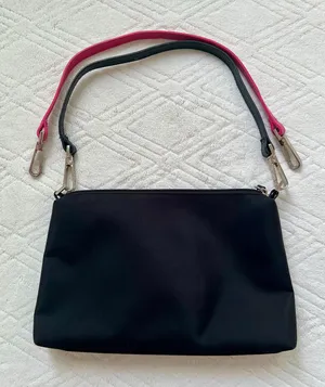 bueno black purse with detachable black and pink straps thumbnail 1
