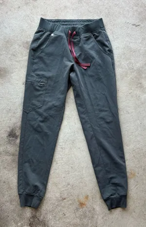 FIGS Zamora Jogger Scrub Pants in the limited-edition bonsai green colorway, featuring a comfortable yoga waistband and contrasting reddish drawstring thumbnail 1