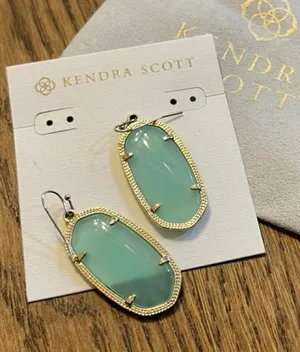 Kendra Scott earrings with light clear‎ turquoise oval stones and gold detailing thumbnail 1