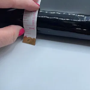 Black faux patent leather clutch with wave design on front. thumbnail 10