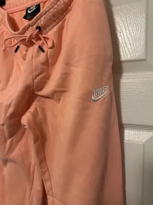 NIKE size small Soft fleece joggers in a warm peach-coral shade. Elastic waistband with adjustable drawstring. Tapered legs with cuffed ankles. Embroidered Nike logo at hip. Cozy everyday women small brand new thumbnail 7