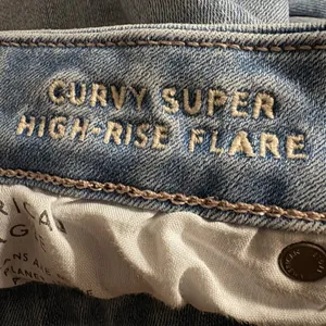 American Eagle Next Level Curvy Super High Rise Flare Jean 14 X-Short Blue thumbnail 5