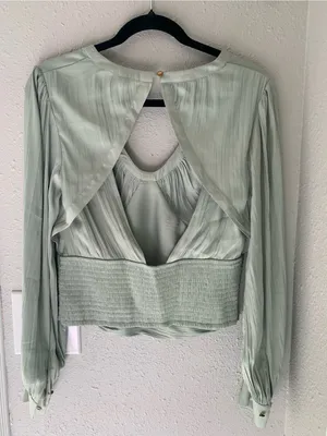 Anthropologie blouson-sleeve blouse is featured in a silky, sage-green fabric. thumbnail 9