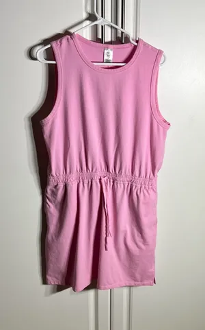 Soft pink sleeveless one-piece with an adjustable drawstring waist for a comfortable fit, with pockets. Lightweight cotton-blend fabric designed for easy movement. Simple, versatile style that pairs well with sneakers or sandals. Member’s mark size large. 57% cotton, 38% polyester, 5% spandex thumbnail 1