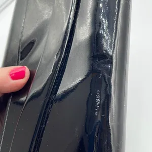 Black faux patent leather clutch with wave design on front. thumbnail 5