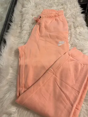 NIKE size small Soft fleece joggers in a warm peach-coral shade. Elastic waistband with adjustable drawstring. Tapered legs with cuffed ankles. Embroidered Nike logo at hip. Cozy everyday women small brand new thumbnail 2