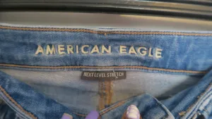 American Eagle Outfitters next level stretch super hi-rise flare jeans in medium wash blue size 4. thumbnail 8
