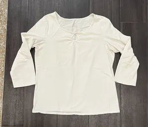 Soft cream long sleeve top with a modest scoop neckline. Features a small decorative ring keyhole at center front. Lightweight, easy to layer for casual or office wear. Simple, clean silhouette for versatile styling. J, Jill size medium. 95% cotton 5% spandex thumbnail 1