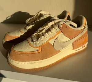 Nike Air Force 1’s Low-Top Sneakers in Cream tan and Orange thumbnail 1