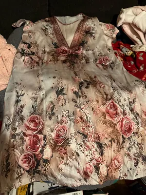 Elegant blush pink floral maxi dress with a V-neck and soft flowing fabric. Features romantic rose print and subtle lace-trim detail at the neckline. Lightweight and feminine for day or evening wear. Blush pink color complements neutral accessories. thumbnail 6