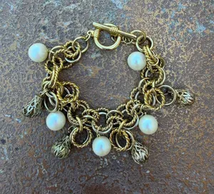 vintage gold-tone chain-link charm bracelet featuring chunky twisted links, faux pearls, ornate metal charms & front toggle clasp #statement thumbnail 1