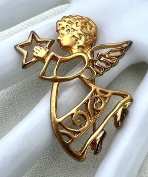 Gold tone angel holding star brooch thumbnail 1