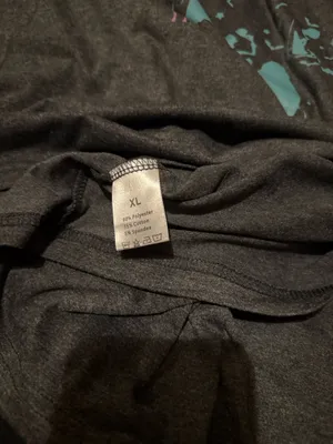 Gray t-shirt featuring a ghost print in teal and pink of the Hitchhiking Ghosts of the Haunted Mansion. Great for Disney parks and Halloween parties. thumbnail 2