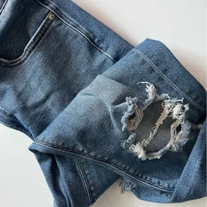 American Eagle Outfitters • Medium Wash Destructed Mom Jeans thumbnail 3