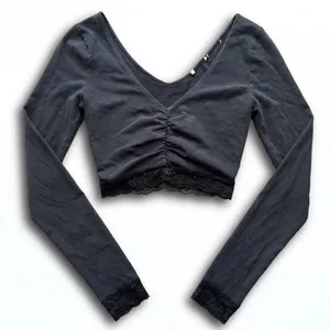 Black Long Sleeve V-Neck Ruched Crop Top with Lace Trim Hem and Cuffs thumbnail 1