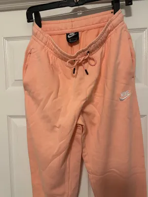 NIKE size small Soft fleece joggers in a warm peach-coral shade. Elastic waistband with adjustable drawstring. Tapered legs with cuffed ankles. Embroidered Nike logo at hip. Cozy everyday women small brand new thumbnail 5