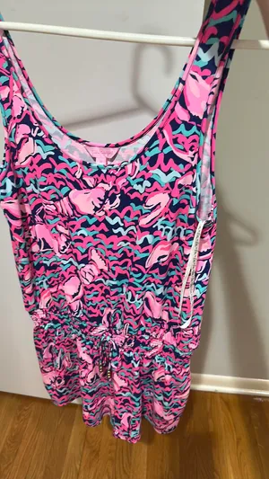 Lilly Pulitzer Romper - Size M Authentic Lilly Pulitzer - Made in China Size: Medium Print: Vibrant abstract in Hot Pink, Navy, Teal / Aqua - Flamingo / shell print - so cute! Style: Sleeveless tank romper, scoop neck, smocked / elastic waist with gold drawstring, shorts bottom show less thumbnail 1