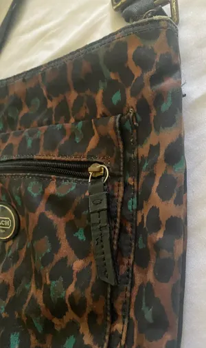 COACH-CHEETAH PRINT NYLON CROSSBODY BAG NO H1376-F77479 Coach crossbody with bold leopard print. Compact silhouette with adjustable shoulder strap. Front zip pocket and main compartment for essentials. Gold-tone logo plaque and hardware accents, front zip pocket, back slip pocket with magnetic closure, adjustable strap, great condition Measures:19.5x9.5 inches thumbnail 10