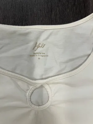 Soft cream long sleeve top with a modest scoop neckline. Features a small decorative ring keyhole at center front. Lightweight, easy to layer for casual or office wear. Simple, clean silhouette for versatile styling. J, Jill size medium. 95% cotton 5% spandex thumbnail 3