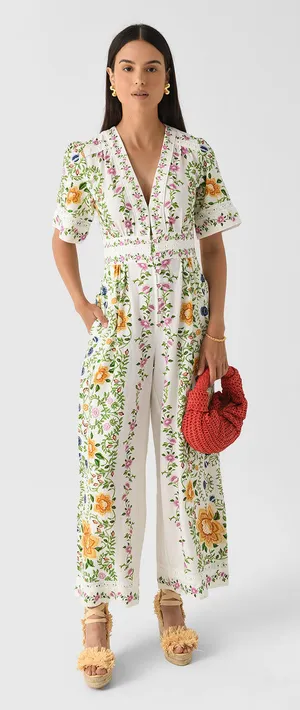 The Farm Rio Folk Floral Jumpsuit features a vibrant print with short sleeves, a V-neckline, and a relaxed, wide-leg silhouette. thumbnail 1