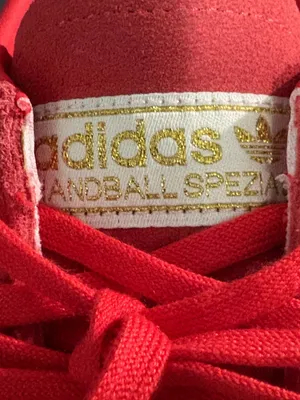 Adidas handball poles in a pretty red with light orange stripes thumbnail 7