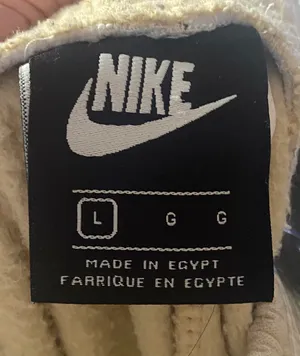 Nike-Sweatpants with Embroidered Logo-size large Soft fleece sweatpants with elastic waistband. Side pockets for storage. Embroidered Nike logo on leg. Neutral cream tone easy to match, 100% polyester, excellent condition Measurements: Waist: side to side 16-20 inches Rise: 12 inches Inseam: 30 inches thumbnail 6