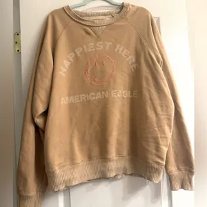 American Eagle Funday Graphic Happiest Here Smiley Tan Sweatshirt - size XL thumbnail 1
