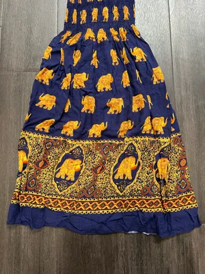 Flowy halter maxi dress with a smocked bodice. Navy base with repeating golden elephant motif. Decorative border print at hem. Lightweight and breezy. Adjustable tie straps. thumbnail 3