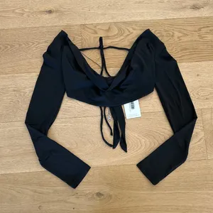 Outcast Clothing - Felicite Long Sleeve Tie Back Top in Black thumbnail 1