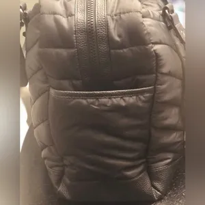 Cynthia Rowley Anthropologie’s Quilted Puffer Travel Bag is a stylish and functional accessory designed for travel enthusiasts. Crafted from high-quality materials, this bag features a quilted exterior for added texture and durability. Its spacious interior provides ample room for belongings, while the thoughtful design includes convenient pockets for organization. The soft puffer style adds a chic touch, making it suitable for various occasions, whether heading to the gym or embarking on a weekend getaway. With comfortable straps for easy carrying, this travel bag combines practicality with fashionable flair. thumbnail 4