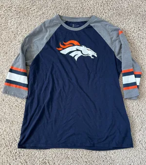 Denver Broncos logo on the chest. Navy body with gray raglan sleeves. Orange and white stripe accents on sleeves. Lightweight fan tee for game days. Nike. Size XL thumbnail 1