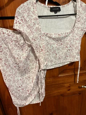 Windsor Set Lovesome white and pink floral two piece with tie detail on the top and bottom of the skirt. #floral #twopiece thumbnail 1