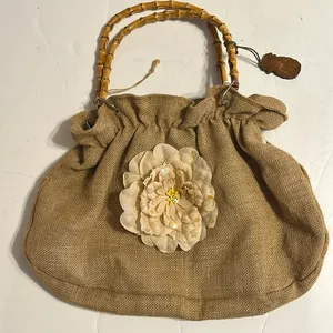Tan purse made from burlap with beige flower and bamboo handles thumbnail 1
