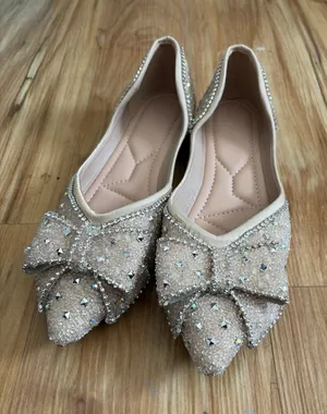 sparkly pointed-toe flat shoes featuring an elegant rhinestone-embellished bow thumbnail 1
