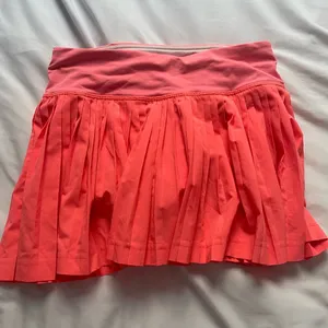 OLD lululemon pleated skirt in coral thumbnail 1