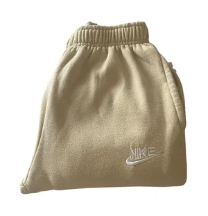 Nike-Sweatpants with Embroidered Logo-size large Soft fleece sweatpants with elastic waistband. Side pockets for storage. Embroidered Nike logo on leg. Neutral cream tone easy to match, 100% polyester, excellent condition Measurements: Waist: side to side 16-20 inches Rise: 12 inches Inseam: 30 inches thumbnail 1
