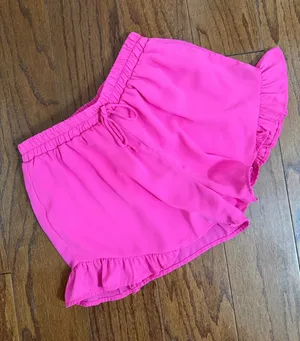 Hot Pink flowy ruffle-hem shorts with elastic drawstring & lightweight - Size M. relaxed design. Gently warn and excellent condition. Measurements approximately 12” waste, not fully stretched out x 12” long. Non-smoking home. priced to sell at as is condition. Don’t like my price, make reasonable offer! And thank you for checking my closet. thumbnail 1