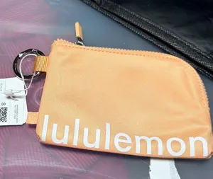 Lululemon Clippable Card Pouch in rare and SOLD OUT Color Peach Bellini/White thumbnail 1