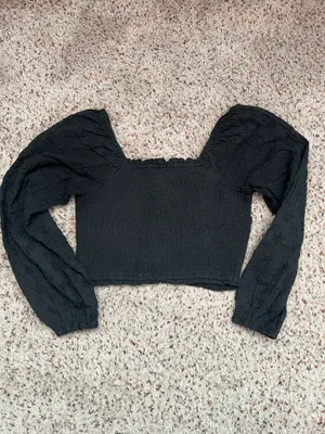 Black smocked crop top featuring dramatic puff sleeves with textured embroidery. Square neckline and fitted bodice create a flattering silhouette. Easy to style for casual or dressed-up looks. American Eagle size medium thumbnail 2