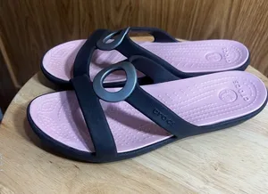 CROCS Women’s Black Slide Sandals with Pink Footbed and Metallic Ring thumbnail 1