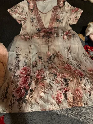 Elegant blush pink floral maxi dress with a V-neck and soft flowing fabric. Features romantic rose print and subtle lace-trim detail at the neckline. Lightweight and feminine for day or evening wear. Blush pink color complements neutral accessories. thumbnail 5