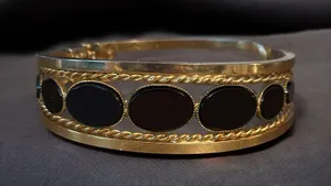 Gold tone open hinged bangle with oval black stones thumbnail 1