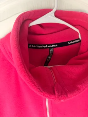 Calvin Klein fleece teddy jacket in vibrant hot pink. Full-zip front with stand collar. Side pockets for hands. Subtle branded detail on the sleeve. Soft, cozy finish for everyday wear. thumbnail 5