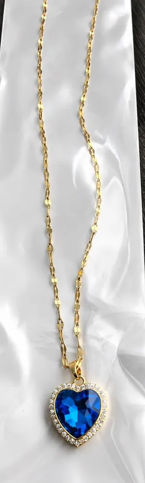 Gold necklace with blue heart thumbnail 1