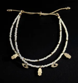 White beaded bolo bracelet with hamsa and evil eye charms thumbnail 2